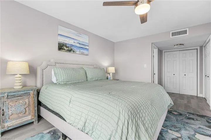 Bedroom with wood finished floors, a closet, and ceiling fan
