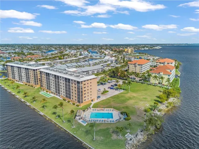 Bird's eye view of a nearby body of water and apartment complex / building