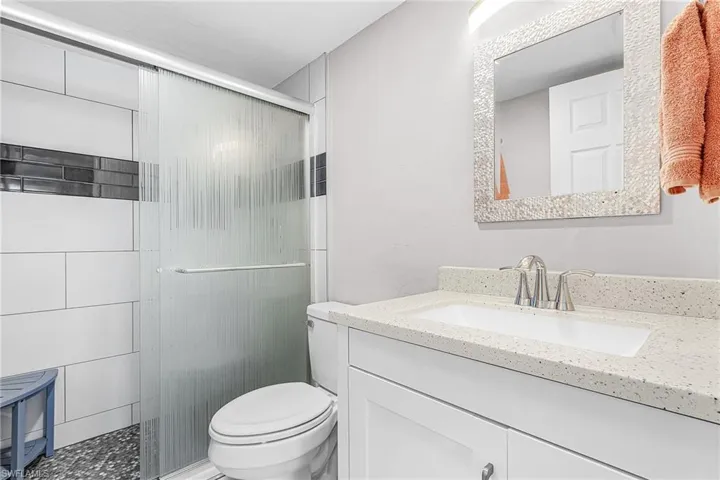Full bath with vanity and a shower stall