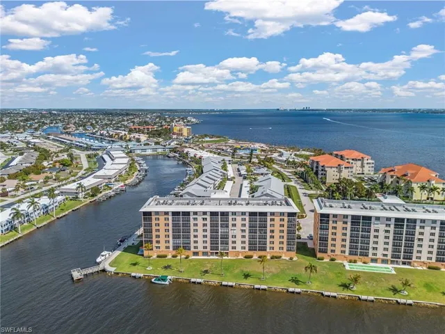 Aerial view of a nearby body of water and apartment complex / building