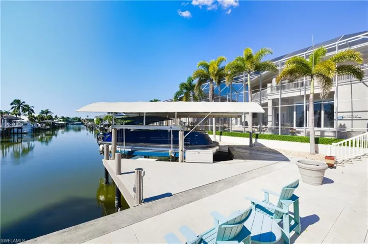 Dock featuring boat lift and a water view