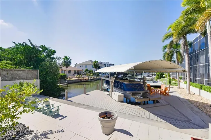 Dock area with boat lift and a water view
