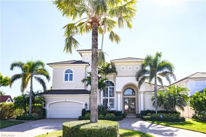 Mediterranean / spanish-style house featuring french doors, decorative driveway, stucco siding, and a garage