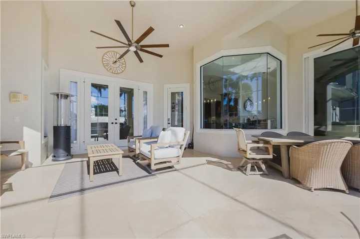 View of patio featuring ceiling fan, french doors, and an outdoor living space