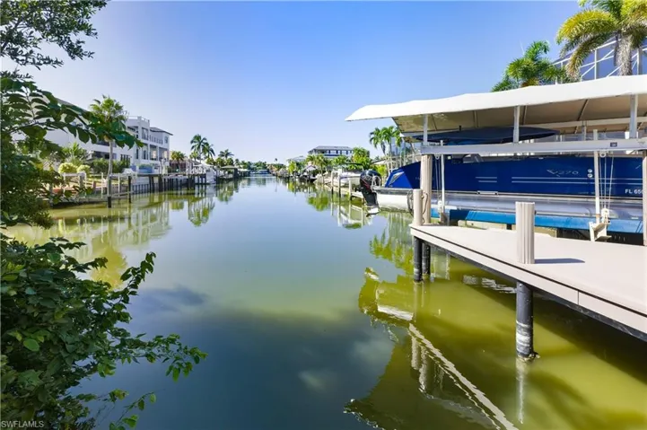 Dock featuring boat lift and a water view