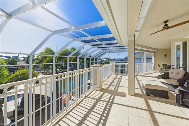Balcony with a sunroom and a ceiling fan