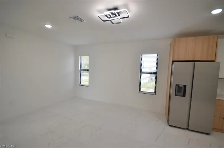 Unfurnished bedroom with a closet, visible vents, marble finish floor, and baseboards