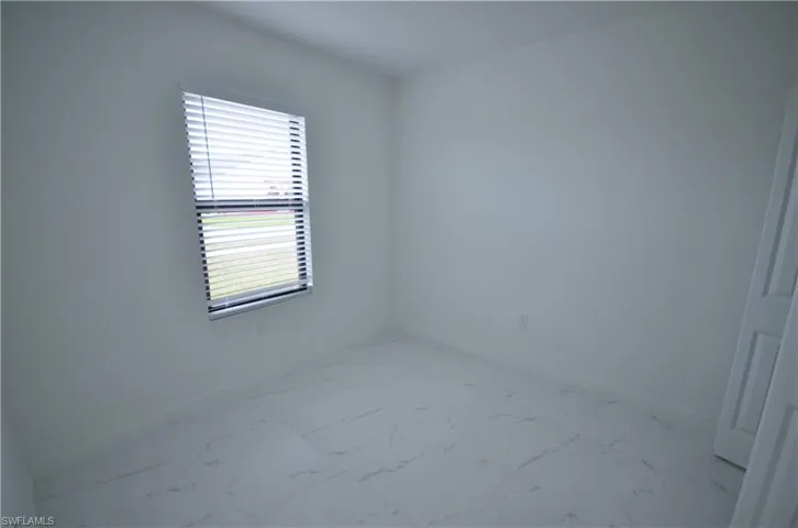 Unfurnished room with visible vents, baseboards, and marble finish floor