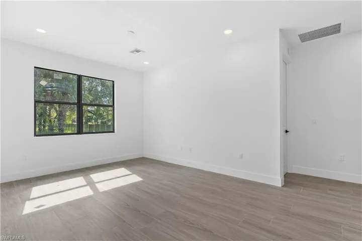 Unfurnished room with light wood finished floors and recessed lighting