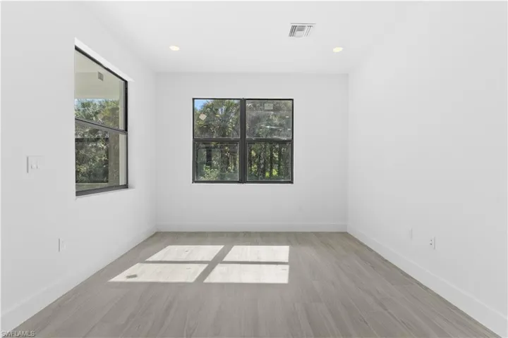 Spare room with plenty of natural light, light wood-style flooring, and recessed lighting