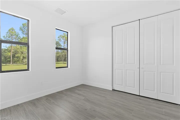 Unfurnished bedroom with light wood-style floors and a closet