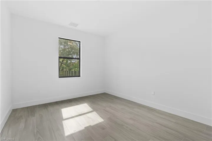 Empty room featuring light wood-style flooring and baseboards