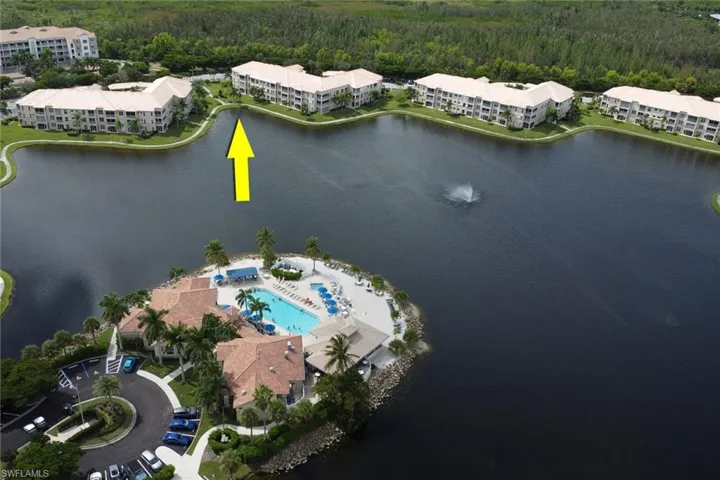 Aerial view of property's location with apartment complex and a forest