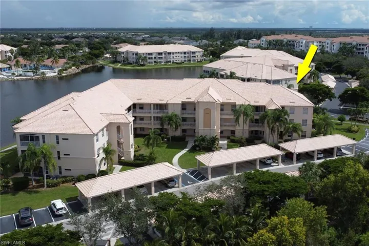 Drone / aerial view of apartment complex and a large body of water