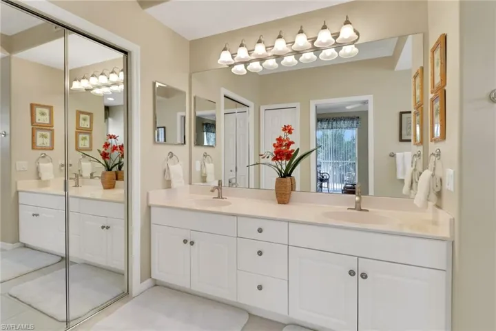 Full bath with double vanity and light tile patterned floors