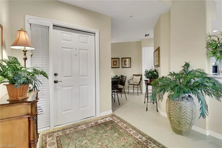 Foyer featuring baseboards and light tile patterned floors