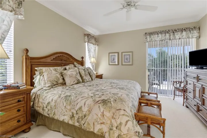 Bedroom featuring light carpet, access to exterior, crown molding, and ceiling fan