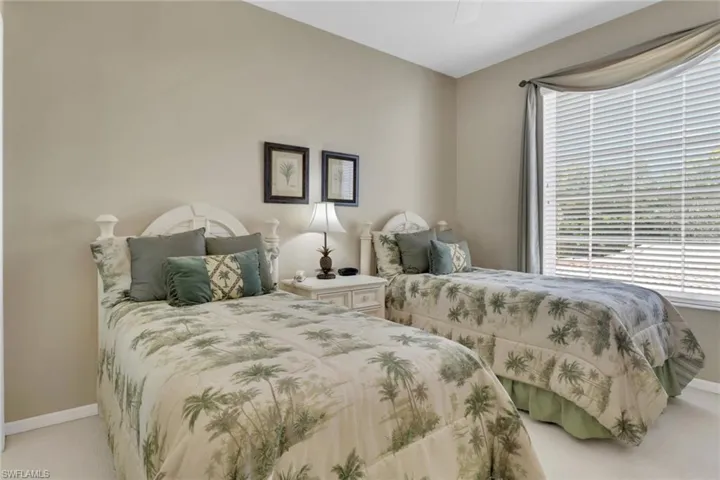 Carpeted bedroom with baseboards and ceiling fan