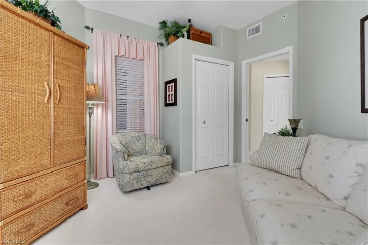 Carpeted living room featuring baseboards