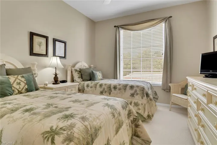 Bedroom featuring light carpet and a ceiling fan