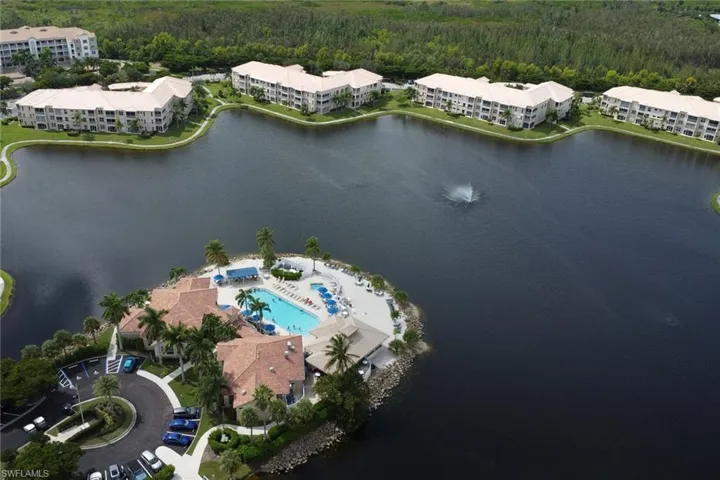 View of property location featuring apartment complex / building and a heavily wooded area