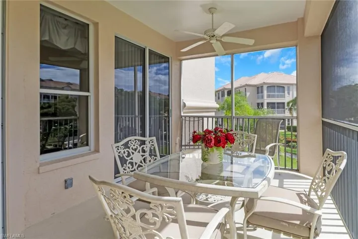 Sunroom with a balcony, outdoor dining area, and a ceiling fan