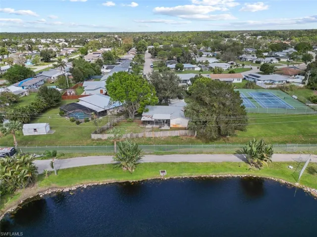Birds eye view of property with a water view