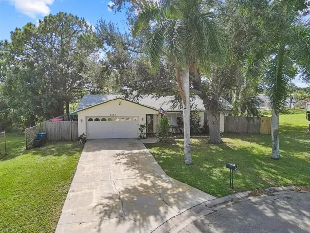 View of front of property with a garage and a front yard