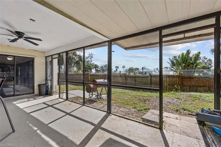 Unfurnished sunroom with wood ceiling, ceiling fan, and plenty of natural light