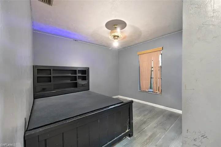 Unfurnished bedroom featuring hardwood / wood-style floors and ceiling fan