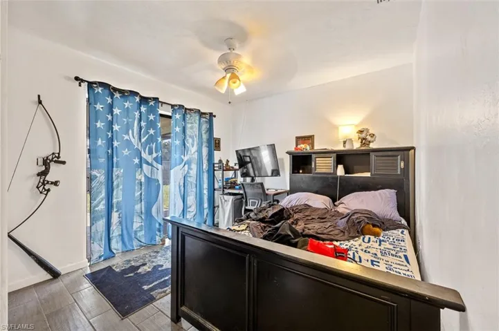 Bedroom with light hardwood / wood-style floors and ceiling fan
