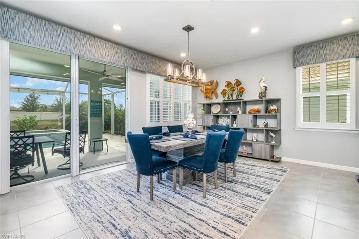 Dining area featuring light tile patterned floors, a chandelier, recessed lighting, and ceiling fan
