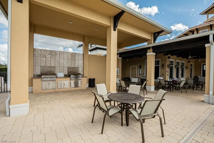 View of patio / terrace with outdoor dining area, area for grilling, and ceiling fan