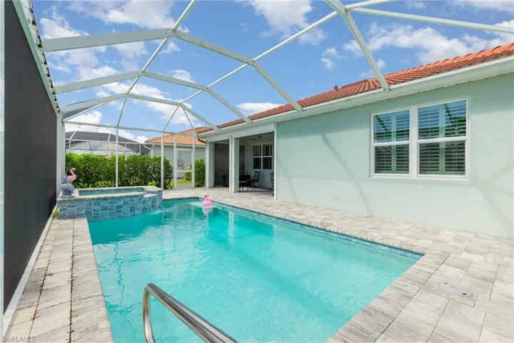 View of pool featuring a sunroom, a patio, a lanai, and a pool with connected hot tub