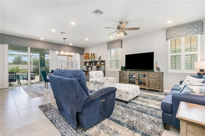 Living room featuring recessed lighting, a ceiling fan, and tile patterned flooring