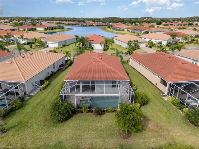 Aerial view of residential area featuring a large body of water
