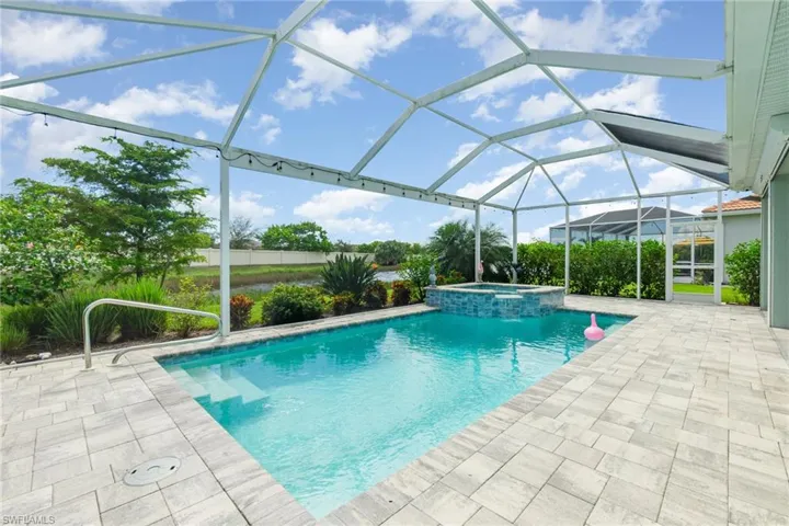 View of swimming pool featuring a sunroom, a lanai, a patio, and a pool with connected hot tub