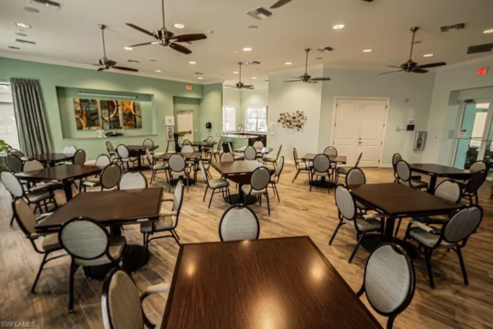Dining space with crown molding, recessed lighting, wood finished floors, and a ceiling fan