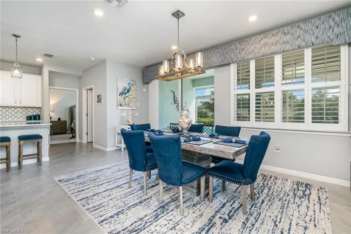 Dining space with recessed lighting and a chandelier