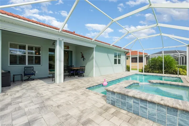 View of swimming pool featuring a sunroom, a lanai, a patio, and a pool with connected hot tub