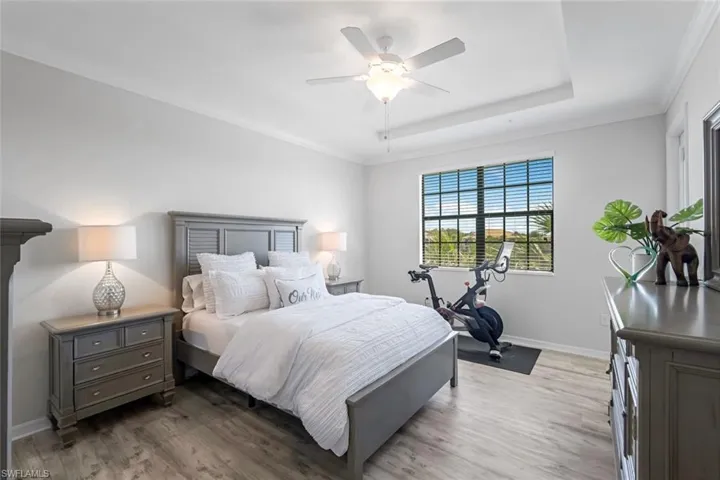 Owner's Bedroom Suite with Luxury Vinyl Plank Floors and French Door to Lanai