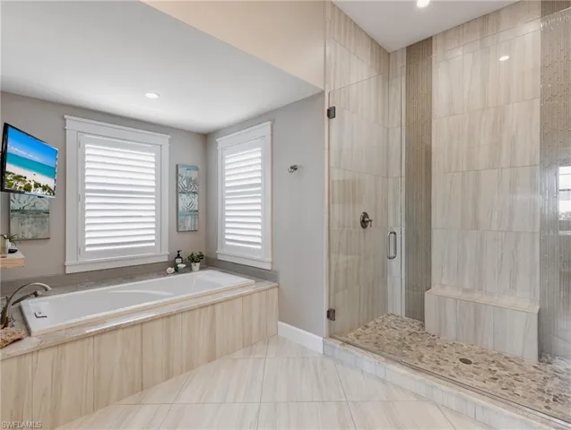 Soaking tab and walk-in shower with floor to ceiling tile