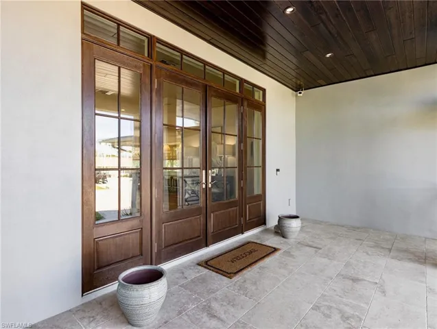 Travertine porch with double door entry