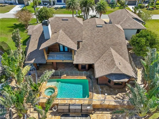 Aerial view of property and surrounding area with a pool