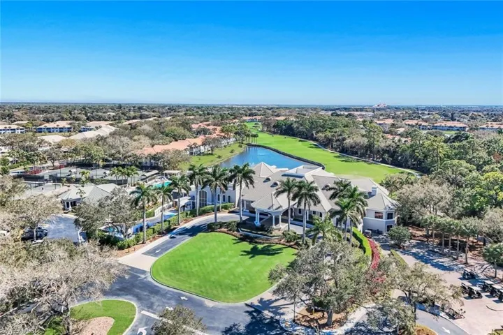 Aerial view of residential area with a nearby body of water and a golf course