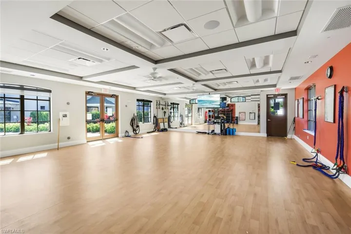 Gym featuring french doors and ceiling fan