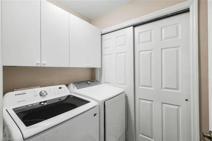 Laundry area featuring washer and dryer and cabinet space