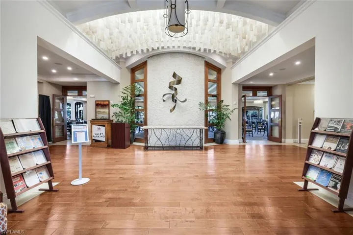 Entryway featuring a high barrel ceiling, light wood finished floors, and recessed lighting