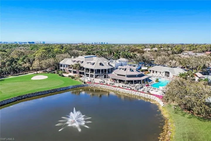 Drone / aerial view of a large body of water and a tree filled landscape