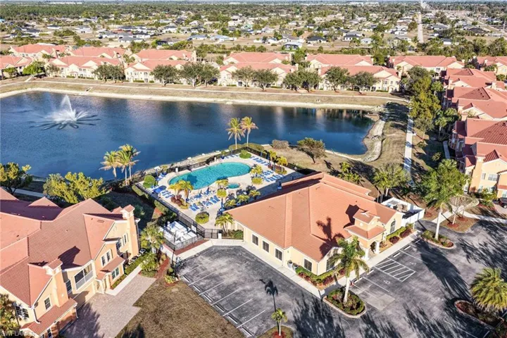 Aerial perspective of suburban area with a large body of water and a pool